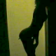 A woman is seen as a shadow against a lighter background as she grows several "tails", which eventually "drop off".